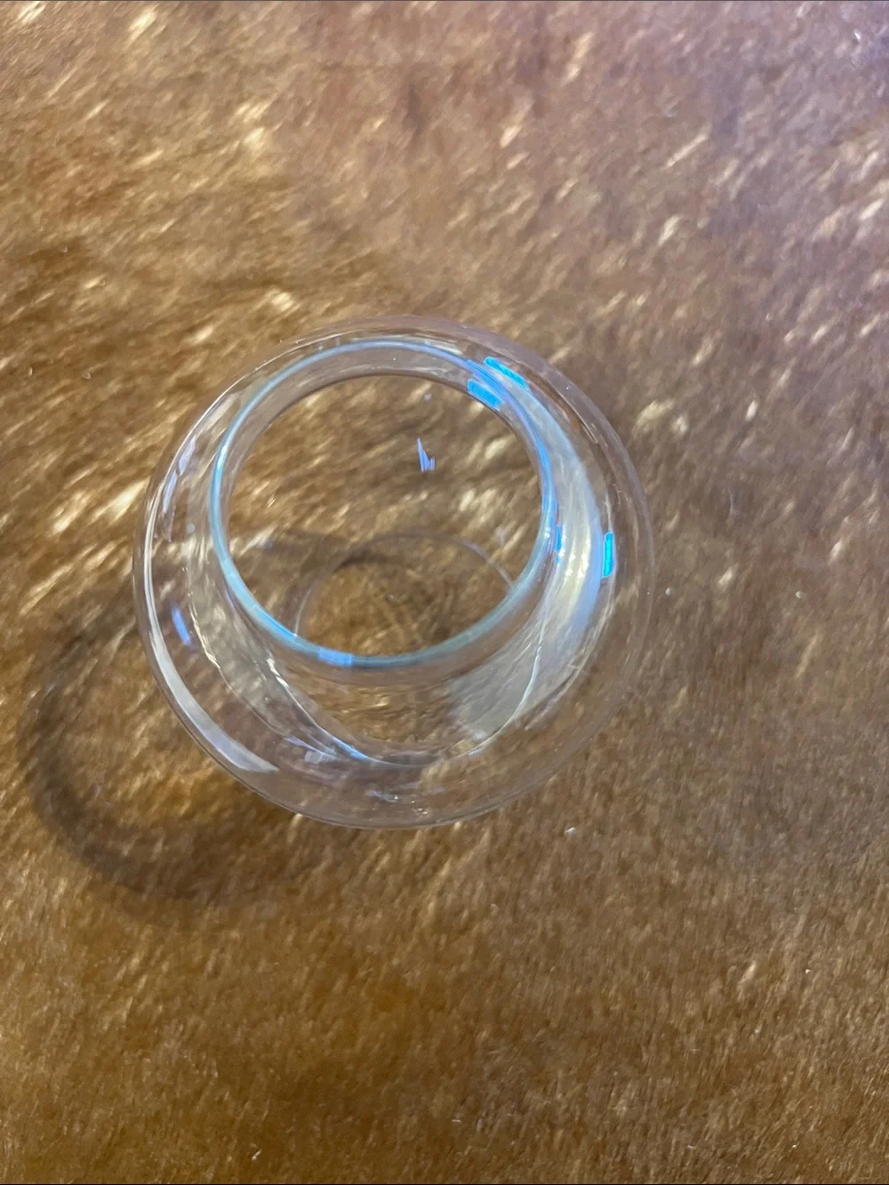 Clear glass hurricane candle holder features a pedestal base and a flared top